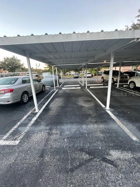 view of vehicle parking featuring a carport