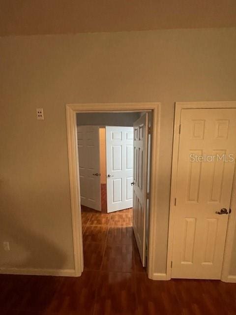 hallway with dark wood-type flooring