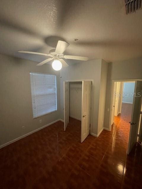 unfurnished bedroom featuring a closet and ceiling fan