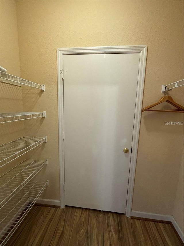 walk in closet with hardwood / wood-style floors