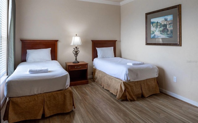 bedroom featuring hardwood / wood-style flooring and ornamental molding