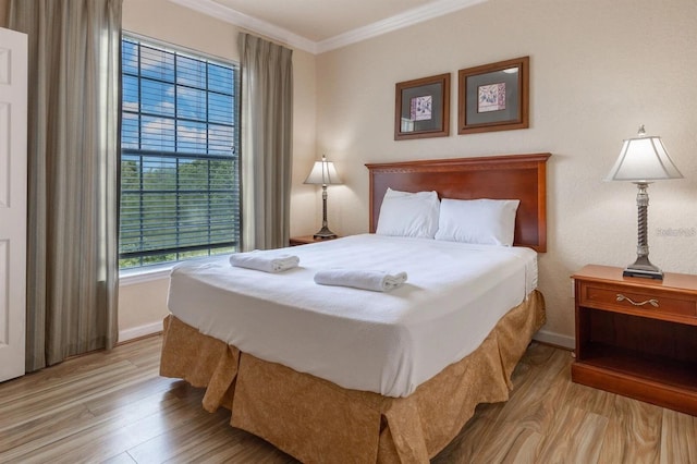 bedroom featuring light hardwood / wood-style flooring and ornamental molding