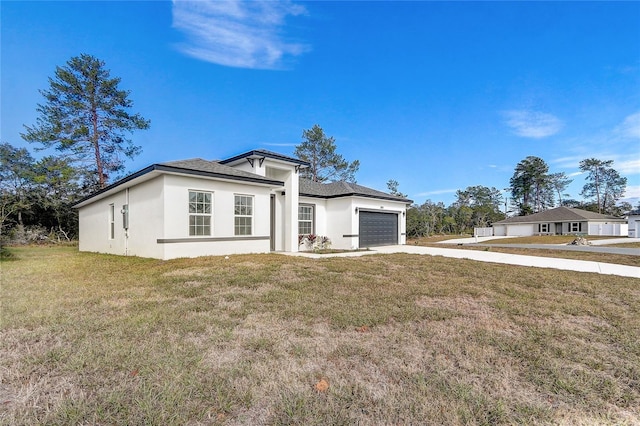 view of front of home with a garage and a front lawn