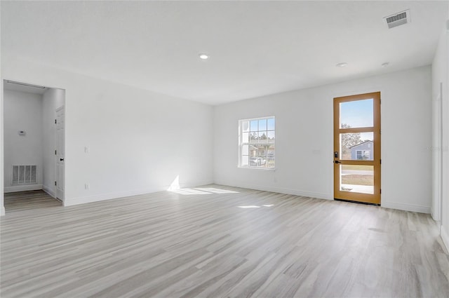 empty room with light hardwood / wood-style flooring