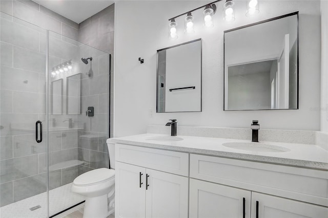 bathroom with toilet, vanity, and walk in shower