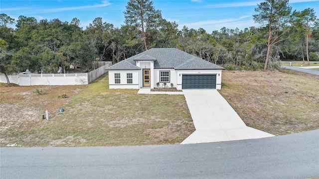 view of front facade featuring a front yard and a garage