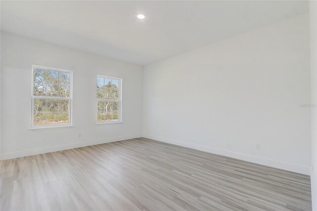 unfurnished room with light hardwood / wood-style flooring