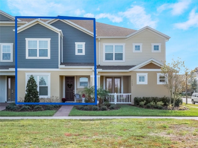 view of front of property with covered porch and a front lawn