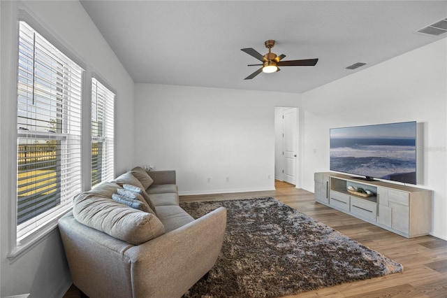 living room with ceiling fan and light hardwood / wood-style flooring