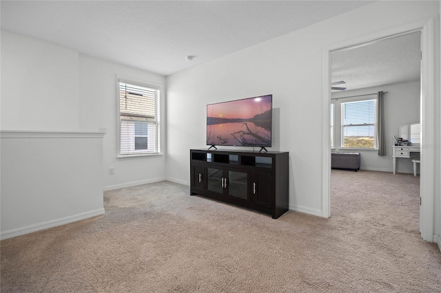 living room with light carpet and ceiling fan