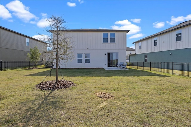 back of property featuring a lawn and a patio area