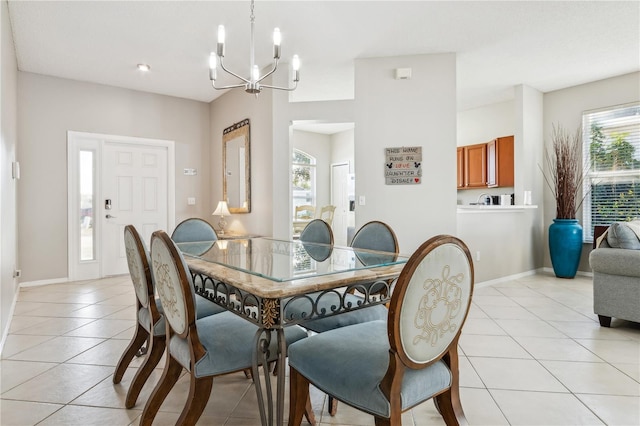 dining area with light tile patterned flooring and an inviting chandelier