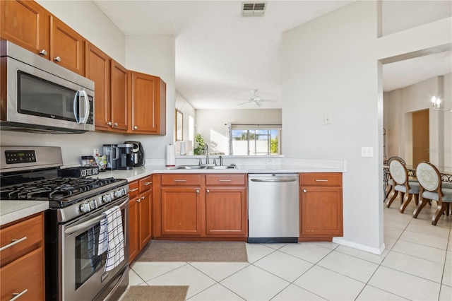 kitchen featuring ceiling fan, light tile patterned flooring, sink, and appliances with stainless steel finishes