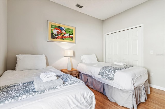 bedroom featuring hardwood / wood-style flooring and a closet