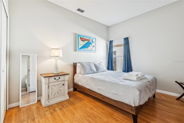 bedroom featuring light hardwood / wood-style floors and a closet