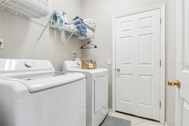 laundry room featuring light tile patterned floors and washing machine and clothes dryer