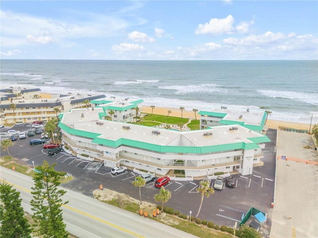 birds eye view of property with a water view and a view of the beach