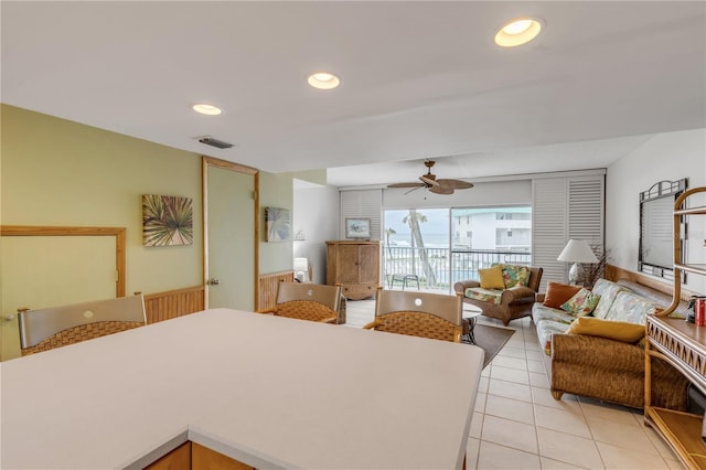 interior space with ceiling fan and light tile patterned floors