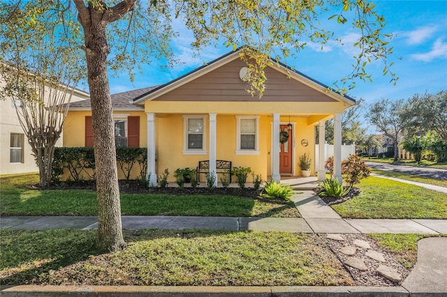 view of front of house with a porch and a front yard