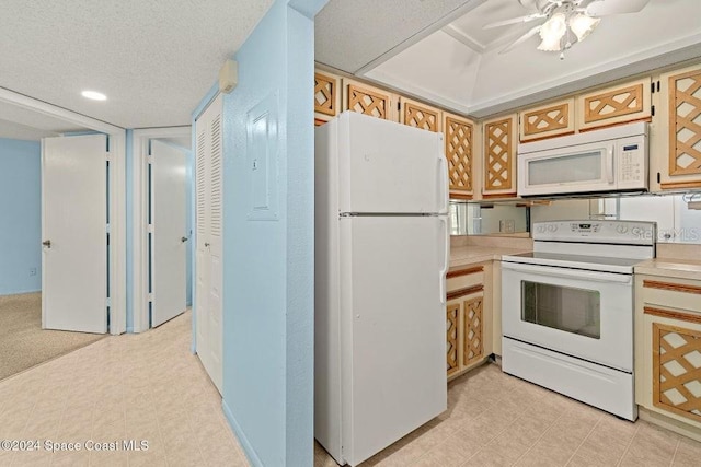 kitchen featuring a textured ceiling, white appliances, and ceiling fan