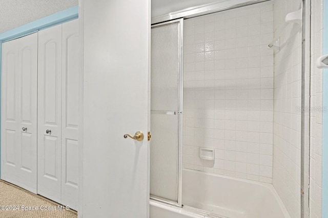 bathroom with shower / bath combination with glass door