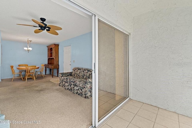 interior space featuring light tile patterned floors and ceiling fan