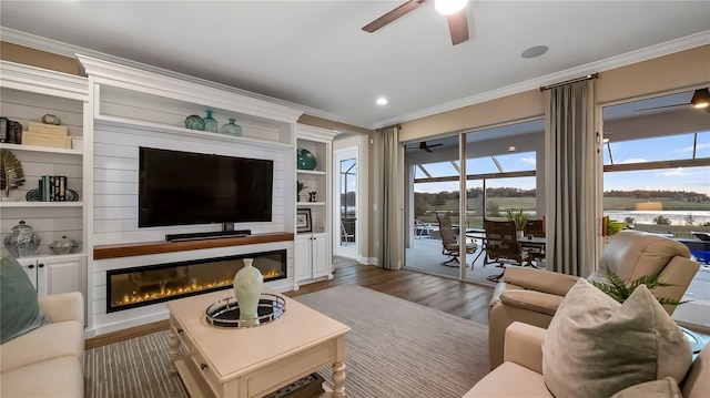 living room with built in features, crown molding, and dark hardwood / wood-style floors