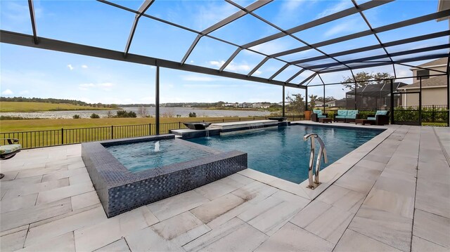 view of swimming pool with a patio area, glass enclosure, pool water feature, and an in ground hot tub