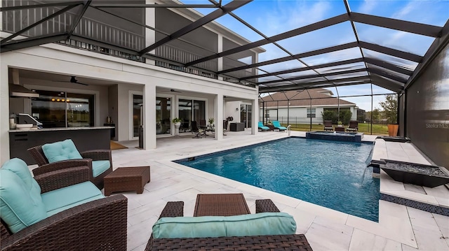 view of pool featuring ceiling fan, a patio, glass enclosure, and outdoor lounge area