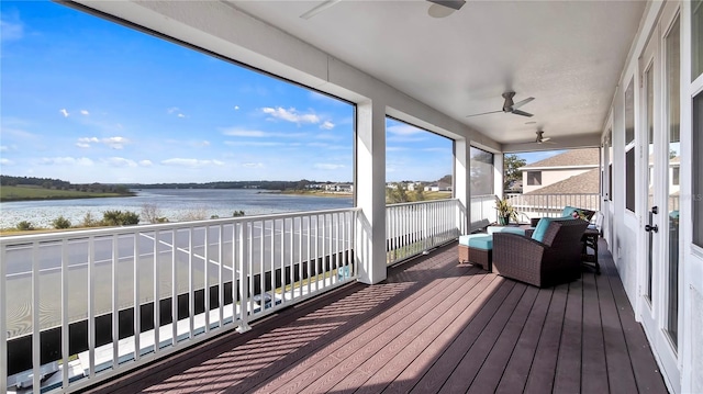 exterior space with ceiling fan and a water view