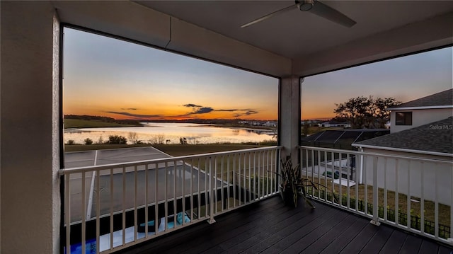 exterior space featuring ceiling fan and a water view