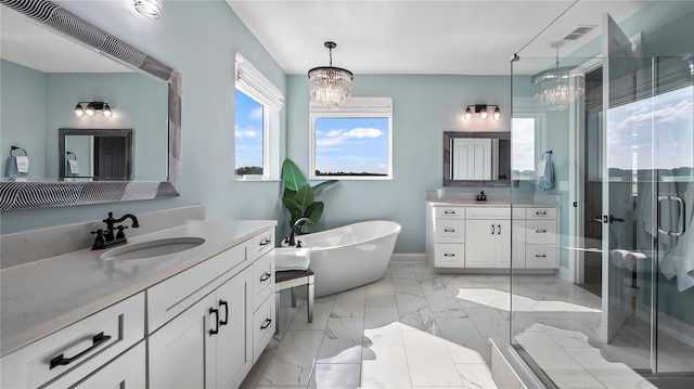 bathroom with independent shower and bath, a notable chandelier, and vanity