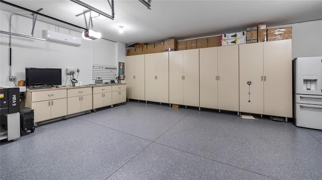 garage with a garage door opener, a wall mounted AC, and white fridge with ice dispenser