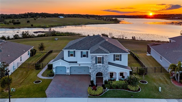 view of front of house with a garage and a water view