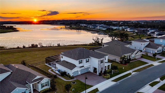 aerial view at dusk with a water view