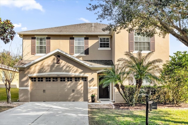 view of front of property featuring a front lawn and a garage