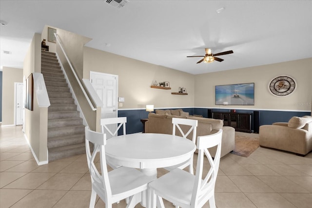 dining room with light tile patterned floors and ceiling fan