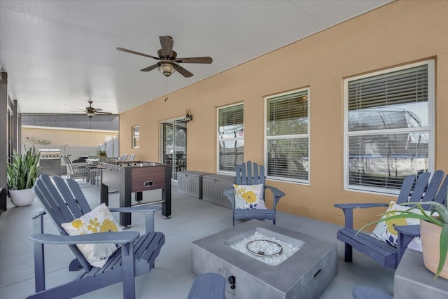 view of patio / terrace featuring ceiling fan and an outdoor fire pit