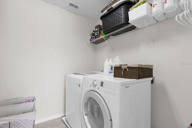 clothes washing area featuring independent washer and dryer and light tile patterned floors