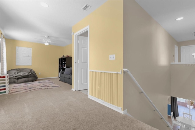 hall with light colored carpet