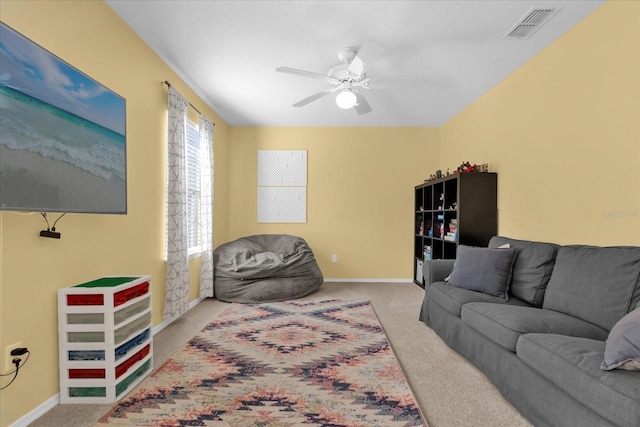 living room featuring ceiling fan and light colored carpet