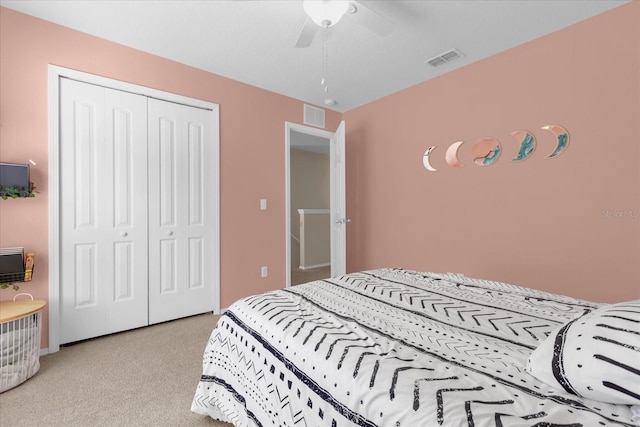 bedroom with ceiling fan, a closet, and light carpet