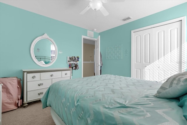 carpeted bedroom featuring a closet and ceiling fan