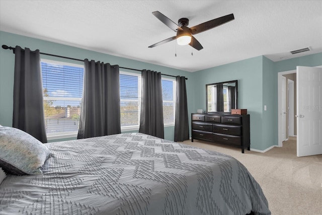 bedroom featuring light carpet and ceiling fan