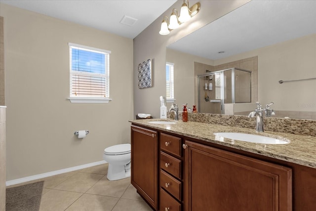 bathroom with tile patterned floors, a wealth of natural light, a shower with door, and vanity