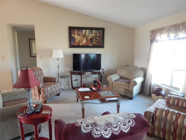 living room with light carpet and vaulted ceiling