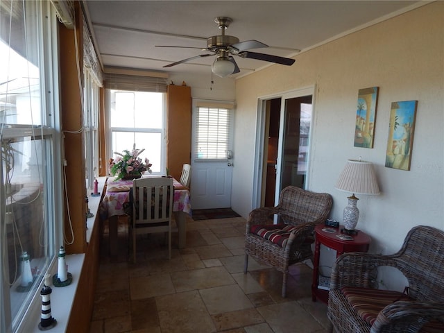 sunroom featuring ceiling fan