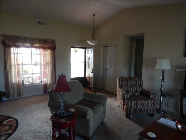 carpeted living room with lofted ceiling