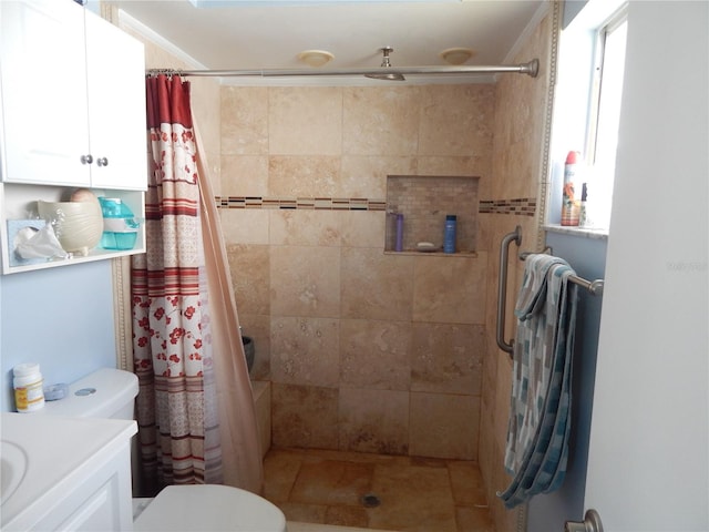 bathroom with vanity, toilet, and walk in shower