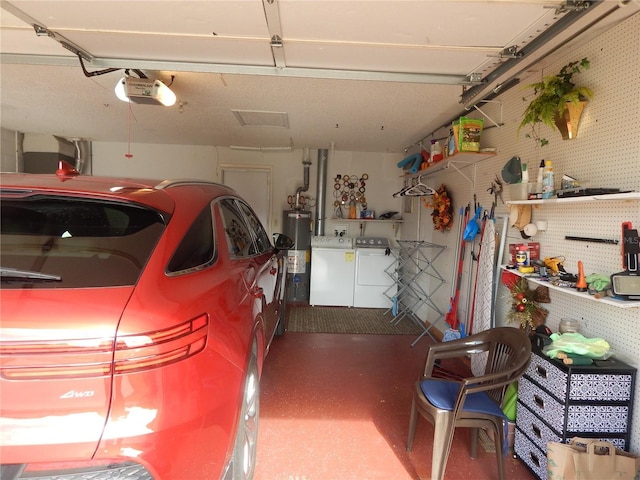 garage with a workshop area, washer and clothes dryer, a garage door opener, and gas water heater